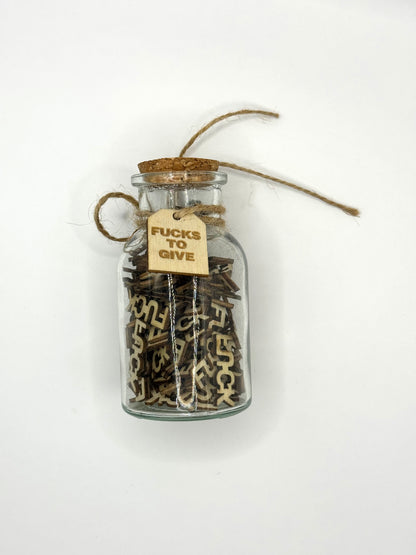 The Swear Jar with cork and a tag filled with Fucks to Give.