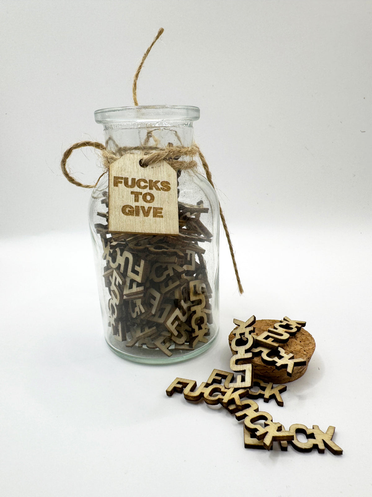 The Swear Jar with wooden letters spelling 'FUCKS TO GIVE' 