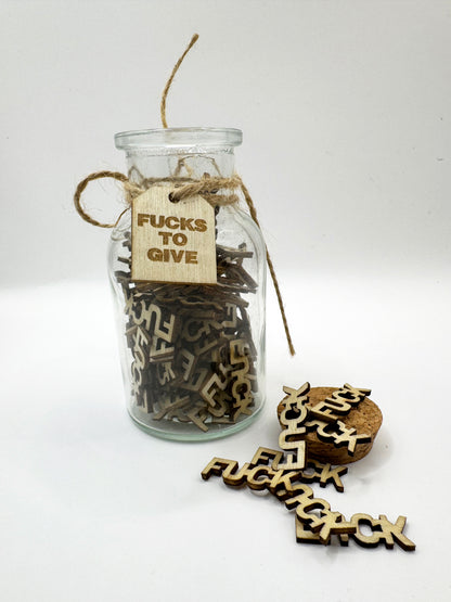 The Swear Jar with wooden letters spelling 'FUCKS TO GIVE' 
