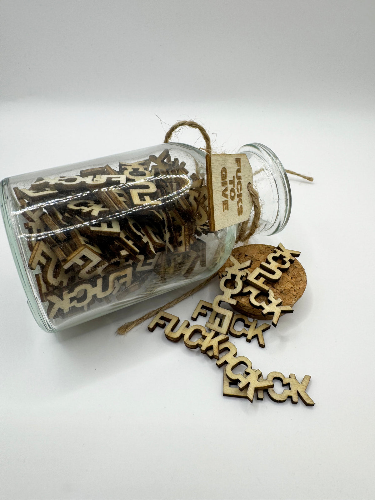 Wooden letters spelling 'FUCK' in The Swear Jar 